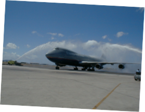 B-747 passing under "Brige" of water from fire trucks